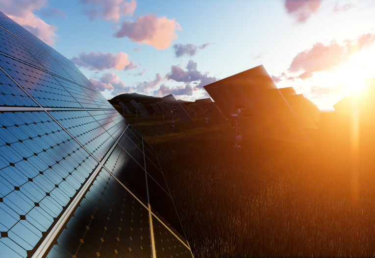 Solar panels at sunset representing renewable energy projects and upcoming Safe Harbor solar tax credit deadlines